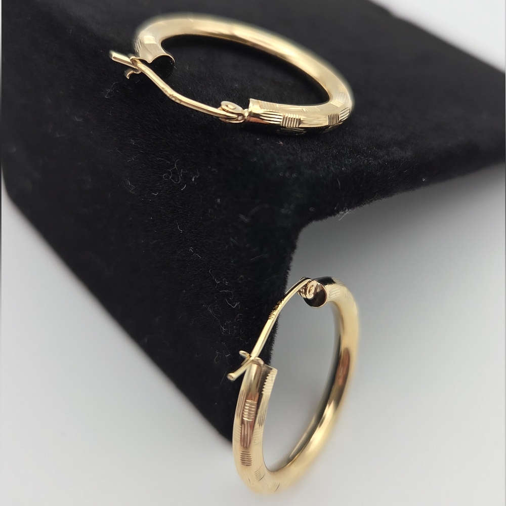 Laser Cut Textured 14kt Gold Hoop Earrings With Wire Closure.